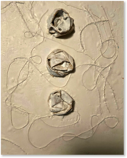 Three clay flower shapes on a textured beige surface with abstract lines.