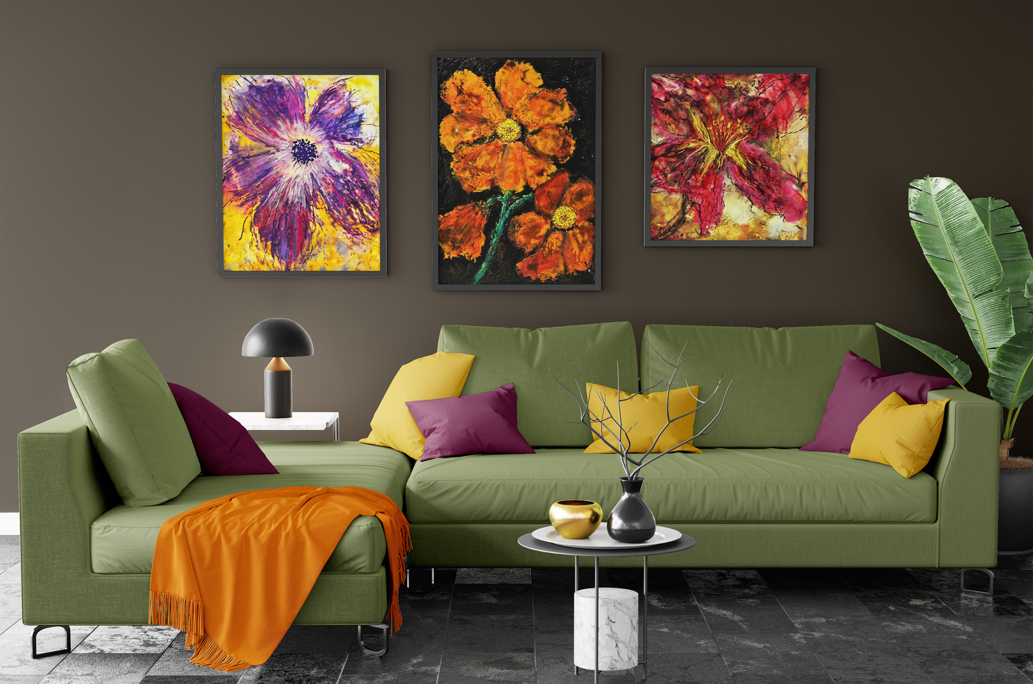 Green sofa with colorful pillows and wall art in a modern living room.